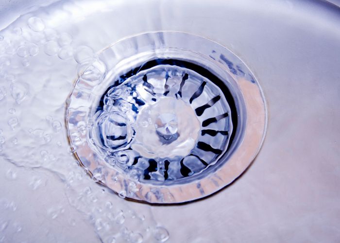 water smoothly draining in sink